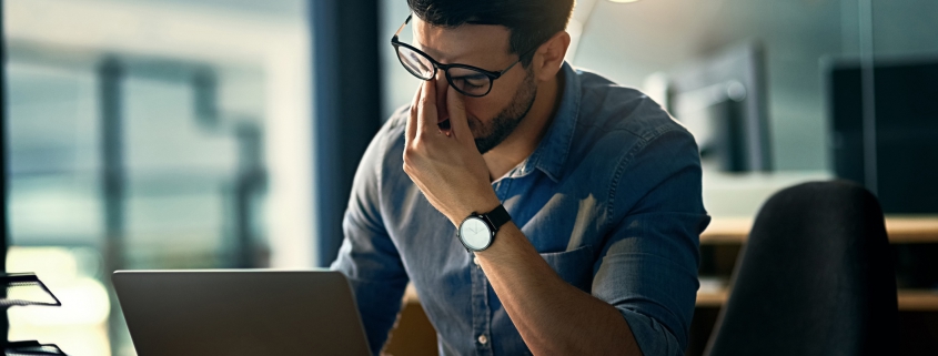 Stressed business owner dealing with hacked laptop