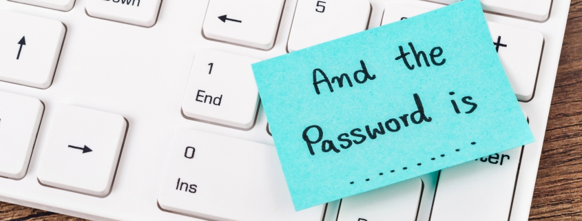 Blue sticky note on white laptop reading "and the password is......"